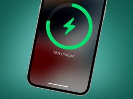 The Apple iPhone 14 charging on a green background