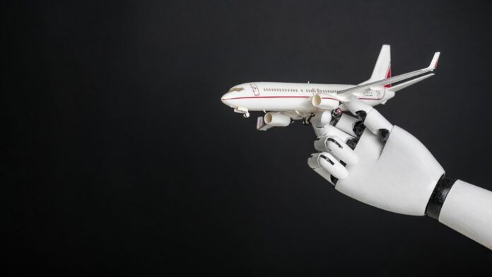 Robotic hand holding airplane model. Integration of robotics and automation in aviation, modernization of flight control technologies