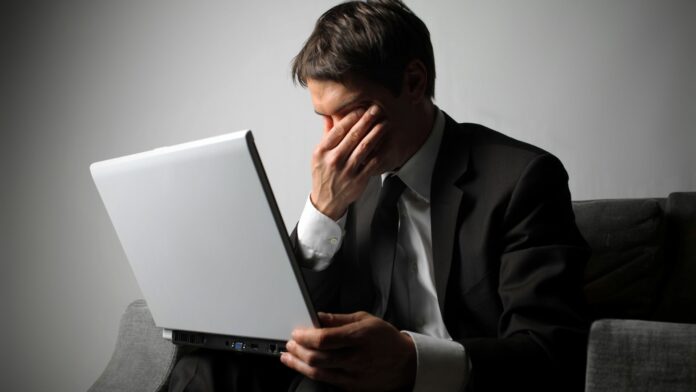 Sad business man and laptop