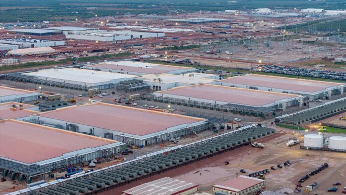 Large warehouse-looking data center buildings are seen from the air.
