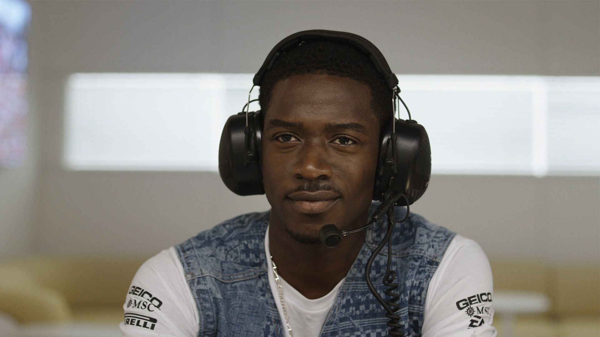 Damson Idris wearing earmuffs in the F1 movie