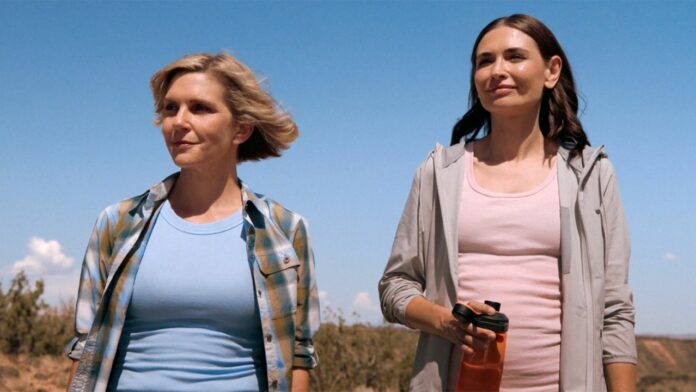 Carol and Zosia standing and smiling in a desert area in Pluribus episode 8