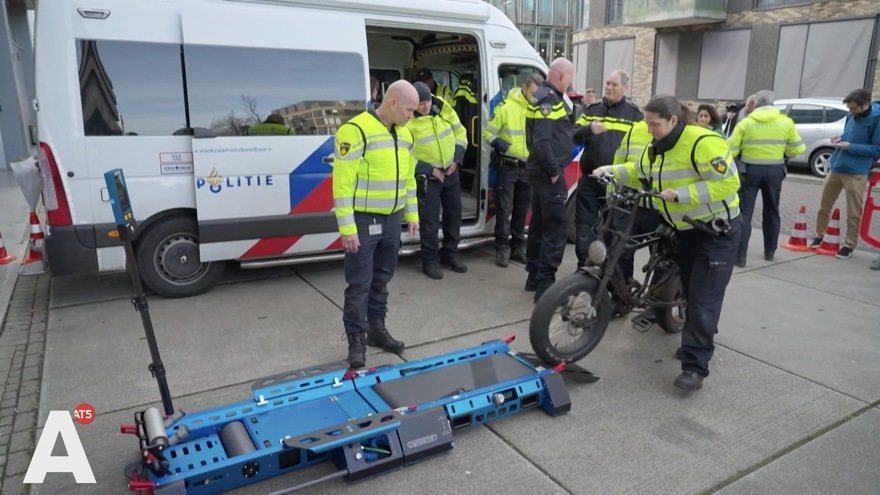 Dutch police officer conducting roadside e-bike speed compliance test using a portable dynamometer roller rig, Netherlands 2026