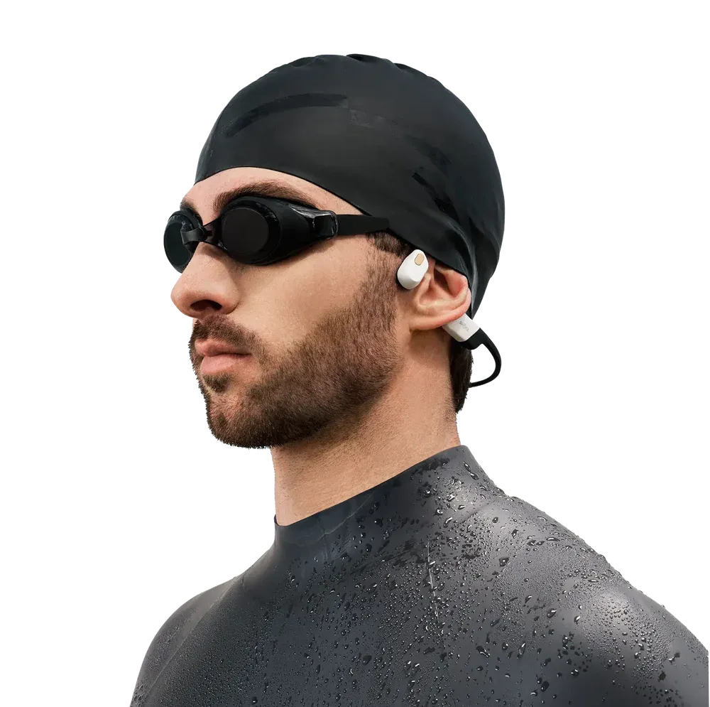 Person wearing Shokz OpenSwim Pro bone conduction headphones during outdoor run